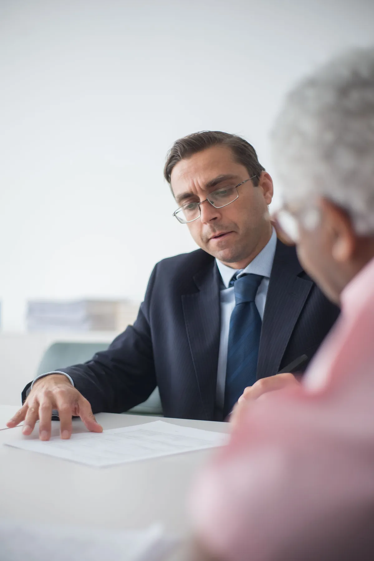 Insurance agent reviewing documents with an older client